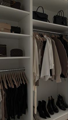 the closet is full of clothes and handbags