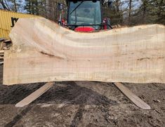 a large piece of wood sitting on top of a pile of dirt