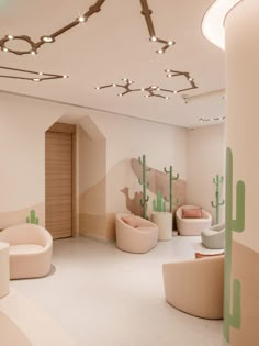 the interior of a modern office with cactus themed furniture and lighting on either side of the room