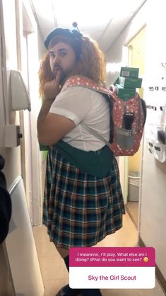 a woman in a school uniform holding a backpack