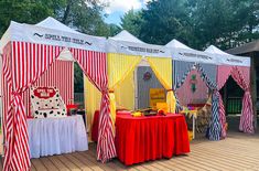 a row of circus tents with red and white striped walls