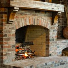 a brick fireplace with an open fire place