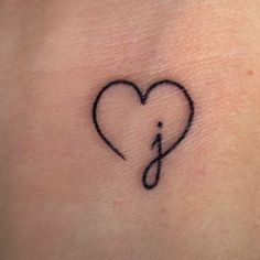 a heart with a musical note tattoo on it