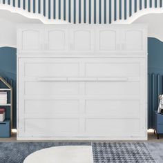 a bedroom with blue walls and white furniture