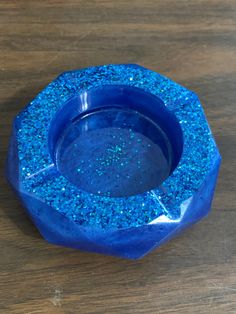 a blue bowl sitting on top of a wooden table