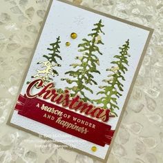 a christmas card with pine trees on it