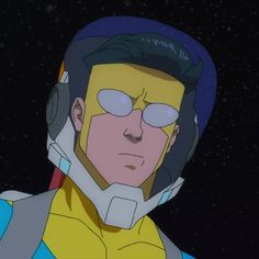 a man with glasses and a helmet in the dark space, looking to his left