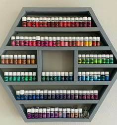 a shelf filled with lots of different types of paint on top of eachother