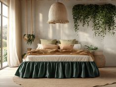 a large bed sitting under a window next to a plant filled wall in a bedroom