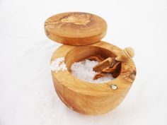 two wooden bowls filled with salt on top of snow