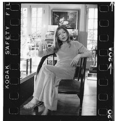 black and white photograph of woman sitting in chair