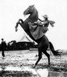 a woman riding on the back of a horse