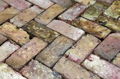 a close up view of a brick floor with chipped paint and rust on it