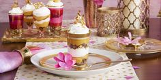 a table topped with plates and cups filled with desserts