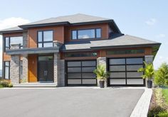 a large house with two car garages on the front and one above it's door