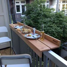 two plates of food sit on a balcony railing