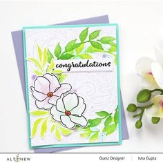 a close up of a greeting card with flowers on it and the words congratulations written in cursive writing