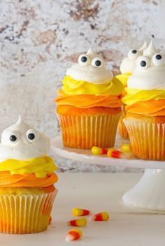 cupcakes decorated with white frosting and candy eyes