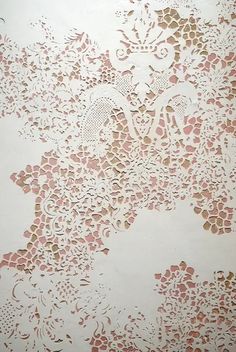 an intricately designed wallpaper with pink and gold flowers on white paper, as seen from above