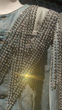 the back of a jean jacket with lots of studding on it's shoulders