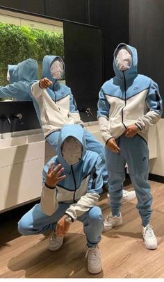 two people in blue and white tracksuits are taking a selfie