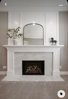 a white fireplace with a mirror above it