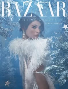 the cover of bazaar magazine featuring a woman in a silver dress and feathered shawl