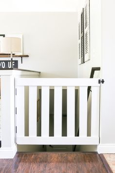 a white crib in the corner of a room