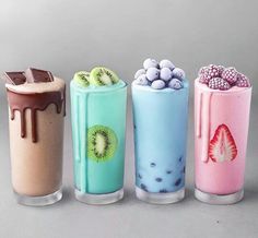 four different types of milkshakes with toppings