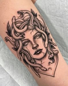 a woman's face with snakes on her arm