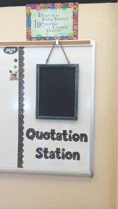 a bulletin board hanging on the wall with words written in it and a chalkboard attached to it