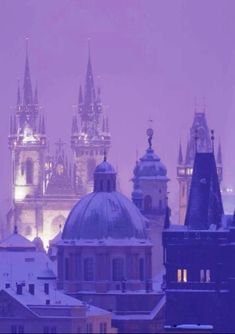 an image of a city skyline in the foggy night time with buildings and spires