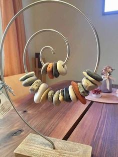 a wooden table topped with lots of different types of rocks on top of a metal stand