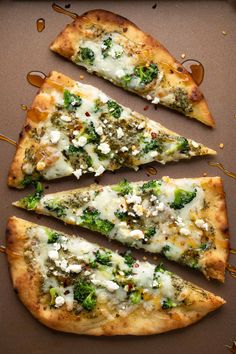 four slices of pizza with broccoli and cheese