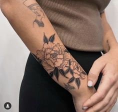 a woman with a flower tattoo on her arm