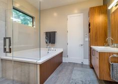 a bathroom with a tub, sink and shower in it's own area is shown