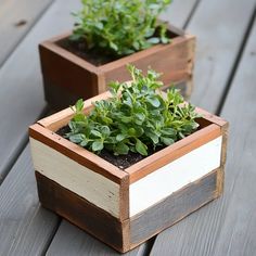 two wooden planters sitting on top of a wooden table