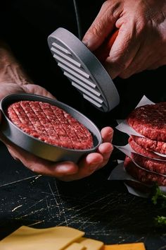 a person holding a hamburger patty in their hands