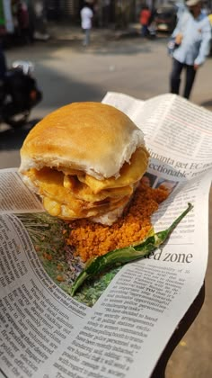 a sandwich sitting on top of a newspaper