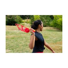 a woman holding a red frisbee in her right hand