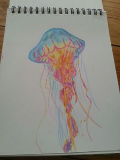 a drawing of a jellyfish on paper with colored pencils and watercolor paints