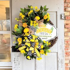 a wreath with yellow flowers on the front door