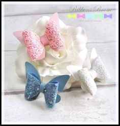 🎀 A gorgeous sparkly set of 3 butterfly hair bow clips! Perfect to keep that fringe up or for sleepover favours! 🎀 These bows features pink, blue and white glitter fabric matched with corresponding coloured leatherette.  The bow measures 5cm by 5cm. Attached to an aligator clip measuring 4.5 cm.  Please feel free to contact me with any requirements, custom makes or questions. Made in a smoke/pet free home. Please read shop policies before purchasing. Follow --------- Checkout my Instagram and facebook pages for new releases, offers, giveaways and discounts! www.instagram.com/ribbonsroom www.facebook.com/ribbonsroom Pink Glitter Hair, Sparkly Set, Flower Girl Hair Clip, Small Hair Bows, Flower Girl Hair, Butterfly Hair Clips, Hair Slides, Sleep Over, Resin Jewelry Diy