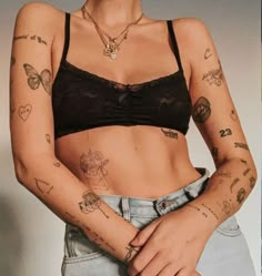 a woman with tattoos on her arms and chest