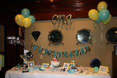 a table with balloons and decorations on it