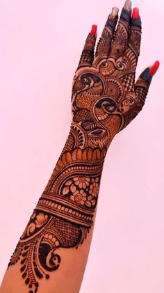 a woman's hand with henna tattoos on it