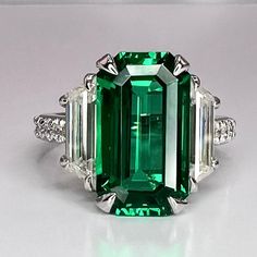 Emerald engagement ring 14K solid gold elongated emerald cut blue sapphire ruby emerald ring May birthstone ring Unique cocktail ring #7756 #EngagementRing #BlueSapphire #EmeraldRing #EmeraldCut #ElongatedEmerald #MayBirthstone #EmeraldGreen #14kSolidGold #UniqueRing #RubyRed Luxury Intricate Emerald Ring For Anniversary, Formal Octagon Emerald Ring May Birthstone, Formal Octagon Emerald Ring For May Birthstone, Rectangular Emerald Ring With Accent Stones For Formal Occasions, Rectangular Emerald Ring With Accent Stones For Formal Events, Formal Emerald Ring With Diamond And Rectangular Stone, Emerald Cut Sapphire Birthstone Ring, Formal Emerald Ring With Rectangular Diamond, Emerald Cut Sapphire Ring Gift