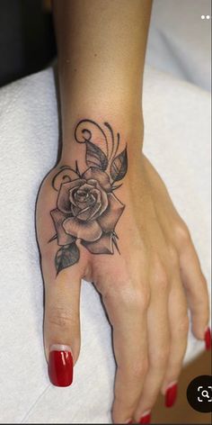 a woman's hand with a rose tattoo on it