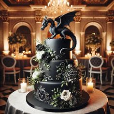 a black wedding cake decorated with flowers and a dragon