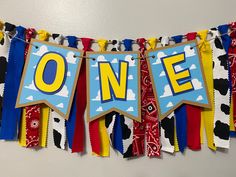 a banner with the word one hanging on a wall